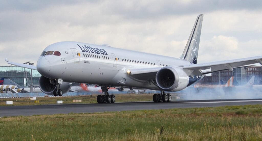 Lufthansa wide-body jet landing on a runway with tire smoke as it touches down